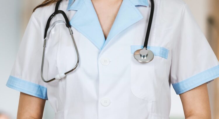 woman in white button up shirt and blue stethoscope