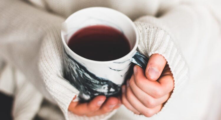 person holding cup of coffee